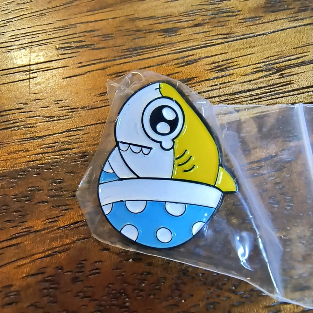 Yellow white cartoon shark in egg enamel pin backpack clothes hat bag denim cap